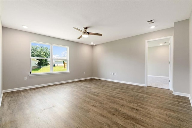 unfurnished room featuring ceiling fan and dark wood-type flooring