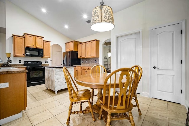 kitchen featuring hanging light fixtures, light tile patterned floors, black appliances, and sink