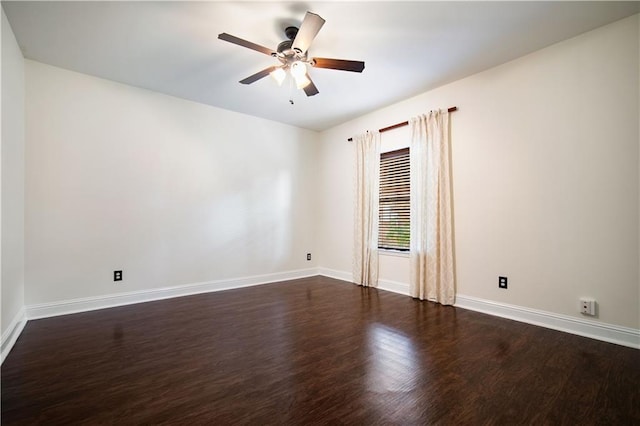 spare room with dark hardwood / wood-style floors and ceiling fan