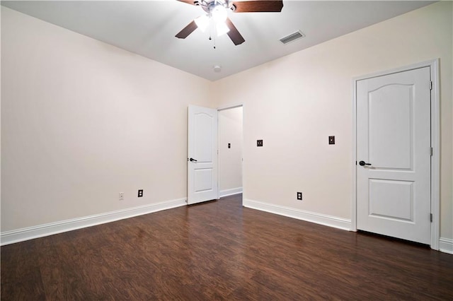 empty room featuring ceiling fan and dark hardwood / wood-style flooring