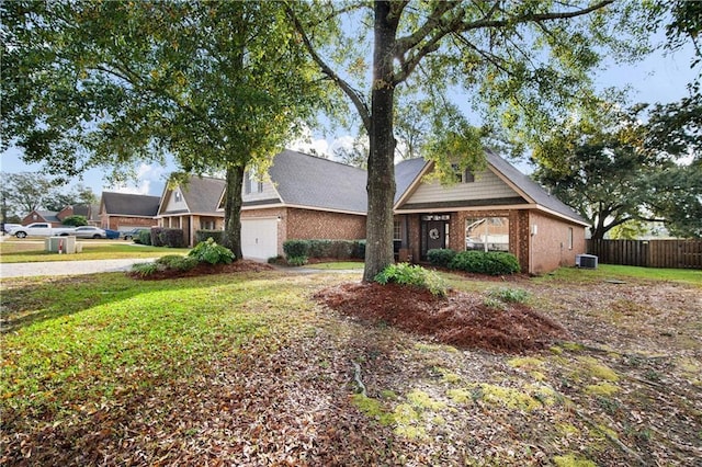 view of front of house featuring a front yard and central AC