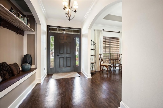 entrance foyer featuring dark hardwood / wood-style flooring, crown molding, and a wealth of natural light