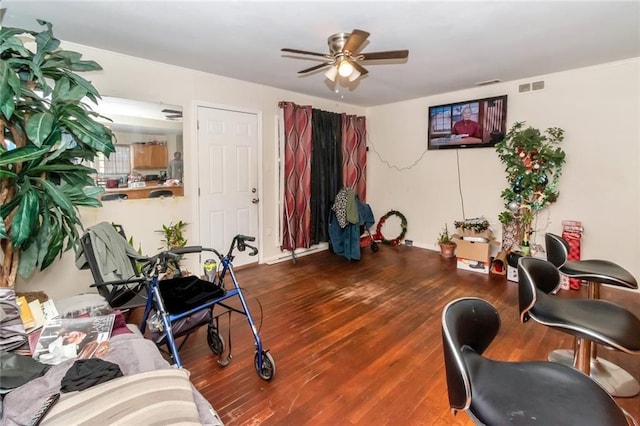 interior space with wood finished floors, ceiling fan, and visible vents