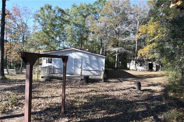 view of property exterior with a deck