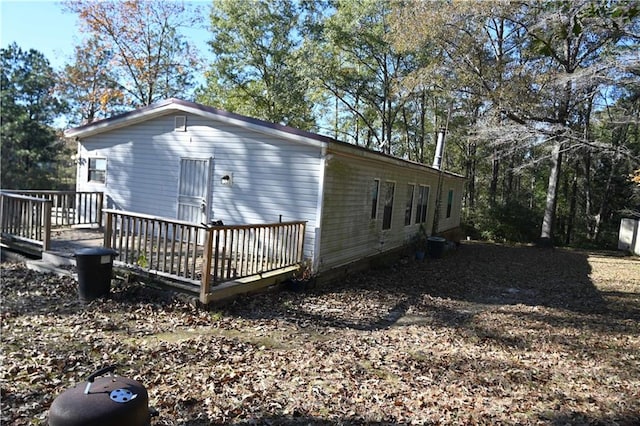 view of side of home featuring a wooden deck