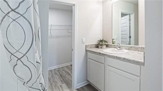 bathroom with vanity and hardwood / wood-style flooring