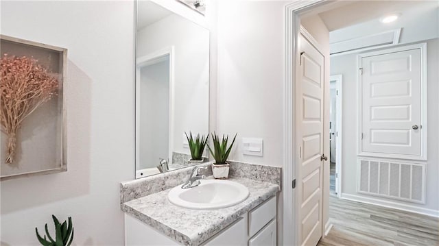 bathroom featuring hardwood / wood-style floors and vanity