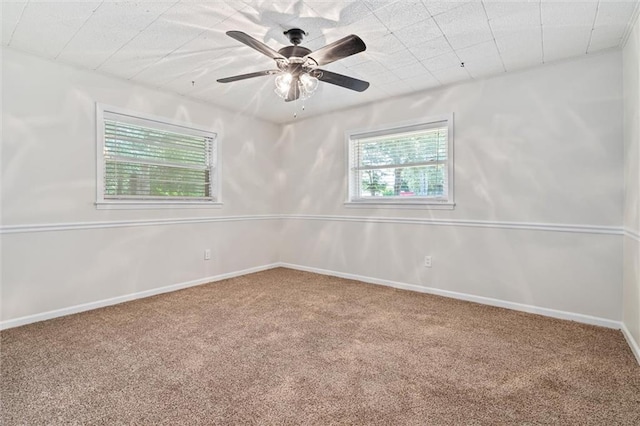 carpeted spare room with ceiling fan