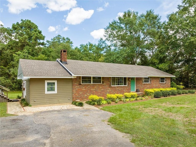 ranch-style house with a front lawn