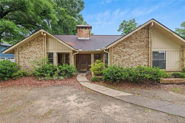 562 Vaughn Dr N, Satsuma, AL 36572 - mid-century home featuring brick siding, a chimney, and roof with shingles