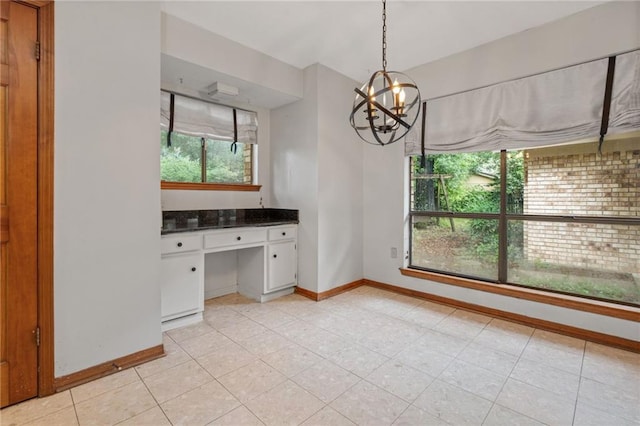 562 Vaughn Dr N, Satsuma, AL 36572 - unfurnished dining area with plenty of natural light, baseboards, and a chandelier