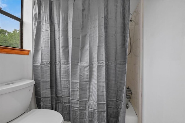562 Vaughn Dr N, Satsuma, AL 36572 - bathroom featuring toilet and shower / bath combo with shower curtain