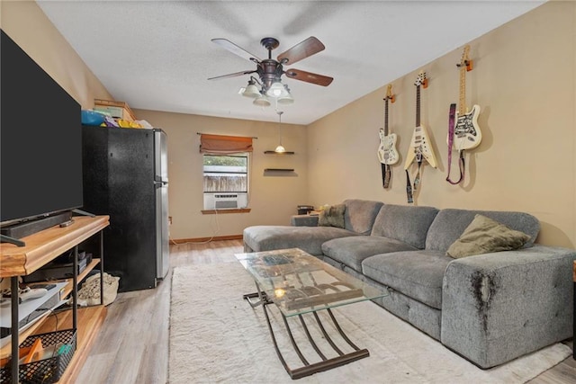 562 Vaughn Dr N, Satsuma, AL 36572 - living room with ceiling fan, light wood finished floors, and cooling unit