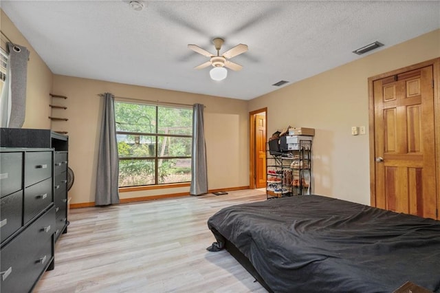 562 Vaughn Dr N, Satsuma, AL 36572 - bedroom with light wood-style flooring, baseboards, a textured ceiling, and a ceiling fan