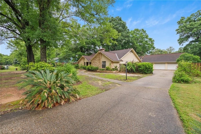 562 Vaughn Dr N, Satsuma, AL 36572 - view of front facade featuring a chimney and a detached garage