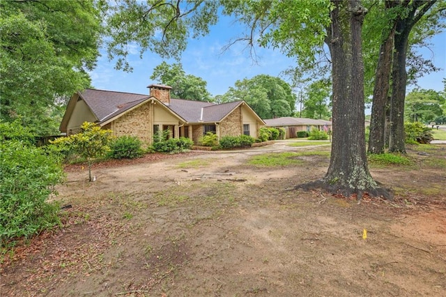 562 Vaughn Dr N, Satsuma, AL 36572 - view of front facade featuring a chimney and brick siding