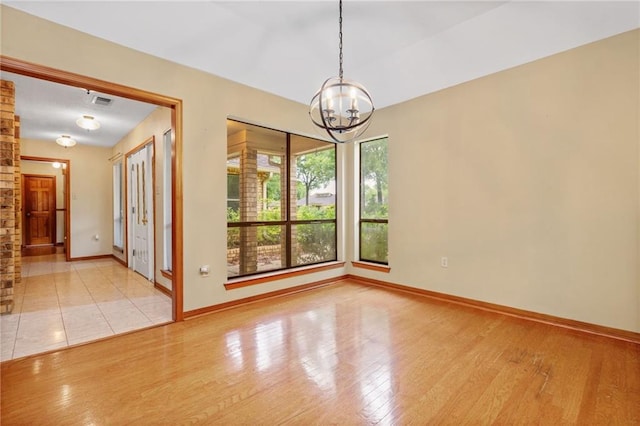 562 Vaughn Dr N, Satsuma, AL 36572 - unfurnished room with a chandelier, baseboards, and wood finished floors