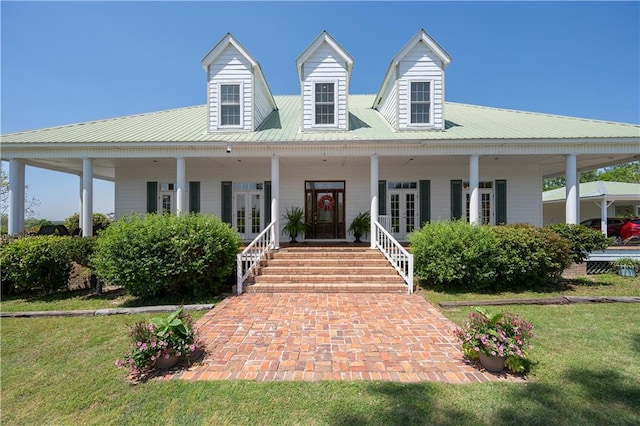 farmhouse-style home with a front yard, a porch, and french doors
