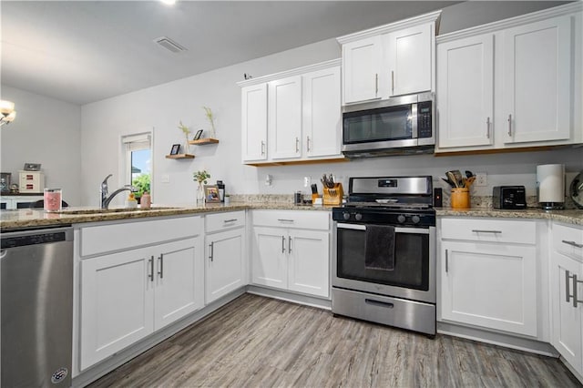 24341 Alydar Loop, Daphne, AL 36526 - kitchen with stainless steel appliances, a sink, and white cabinets