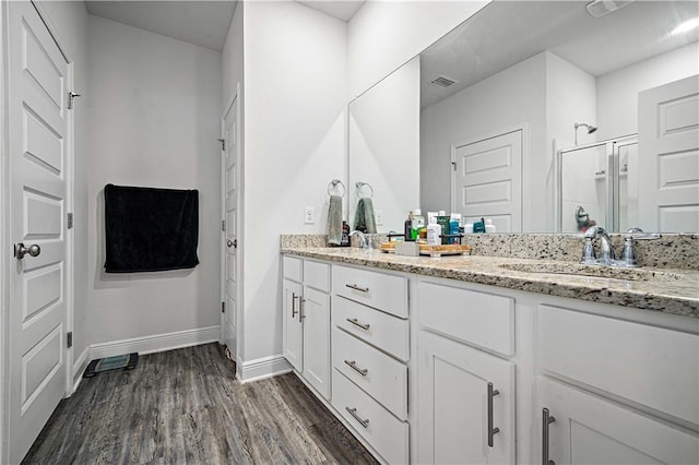 24341 Alydar Loop, Daphne, AL 36526 - bathroom with a stall shower, wood finished floors, double vanity, and baseboards