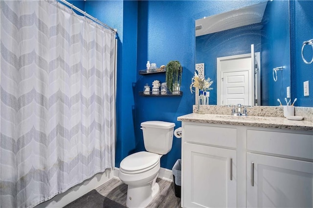 24341 Alydar Loop, Daphne, AL 36526 - full bathroom featuring toilet, vanity, curtained shower, baseboards, and wood finished floors