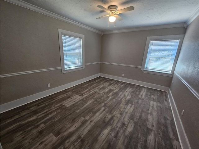 empty room featuring plenty of natural light, ornamental molding, and dark wood-type flooring