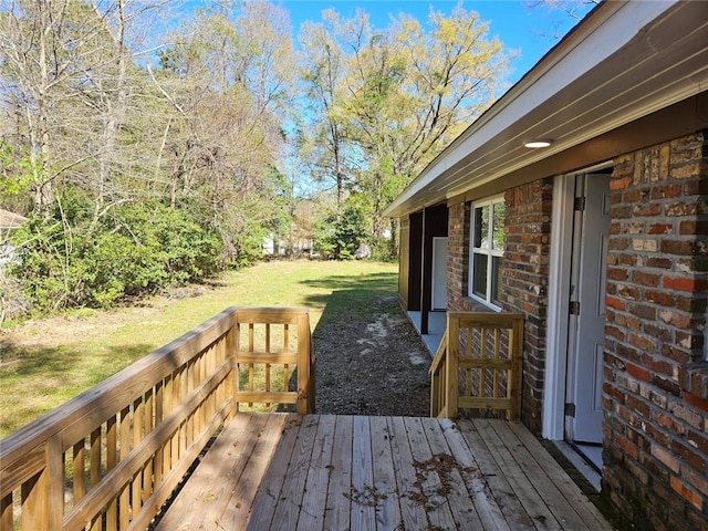 wooden deck featuring a lawn