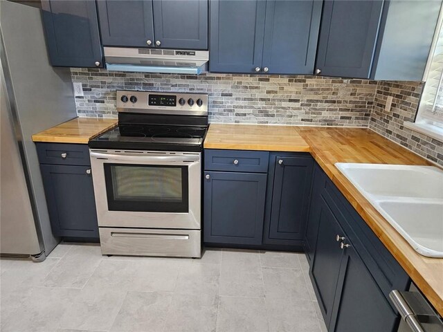 kitchen with tasteful backsplash, stainless steel appliances, under cabinet range hood, a sink, and butcher block counters