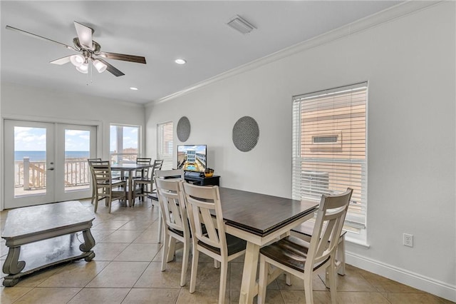 1385 Beach Blvd W, Gulf Shores, AL 36542 - dining area featuring ceiling fan, french doors, crown molding, a water view, and light tile floors