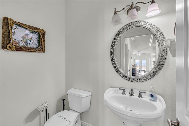 1385 Beach Blvd W, Gulf Shores, AL 36542 - bathroom with ceiling fan, sink, and toilet