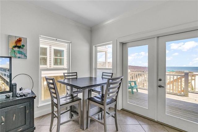 1385 Beach Blvd W, Gulf Shores, AL 36542 - dining room featuring light tile floors, french doors, ornamental molding, and a water view