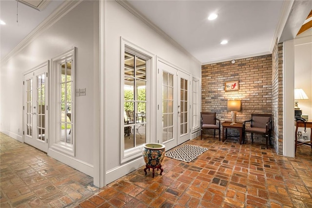 doorway to outside with ornamental molding, brick wall, and french doors