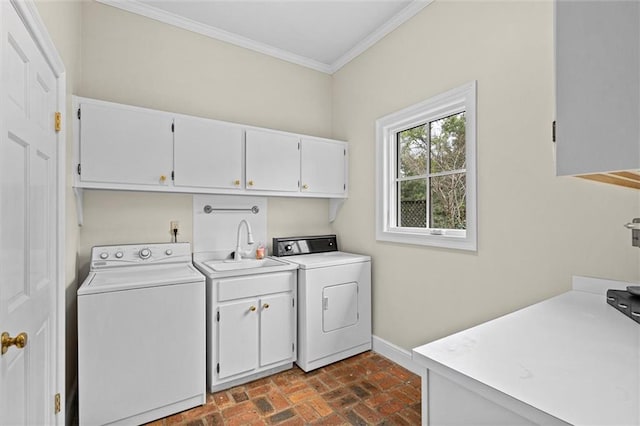 laundry room with crown molding, cabinets, sink, and washing machine and clothes dryer