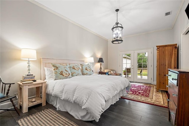 bedroom featuring access to exterior, french doors, crown molding, dark wood-type flooring, and an inviting chandelier