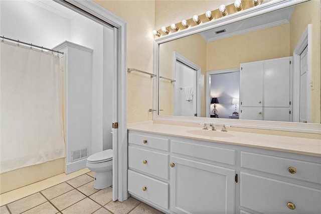 bathroom with tile patterned floors, vanity, toilet, and ornamental molding