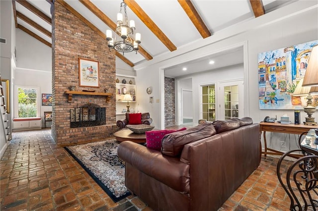 living room featuring a chandelier, beam ceiling, high vaulted ceiling, and a brick fireplace