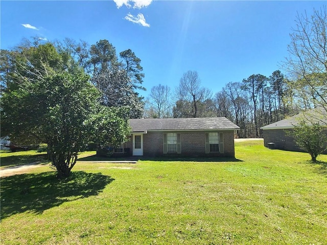 ranch-style house with brick siding and a front yard