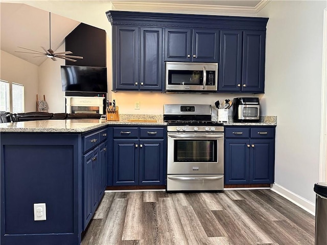 2200 Orourke Dr, Mobile, AL 36695 - kitchen featuring appliances with stainless steel finishes, blue cabinetry, ceiling fan, dark wood-style flooring, and vaulted ceiling