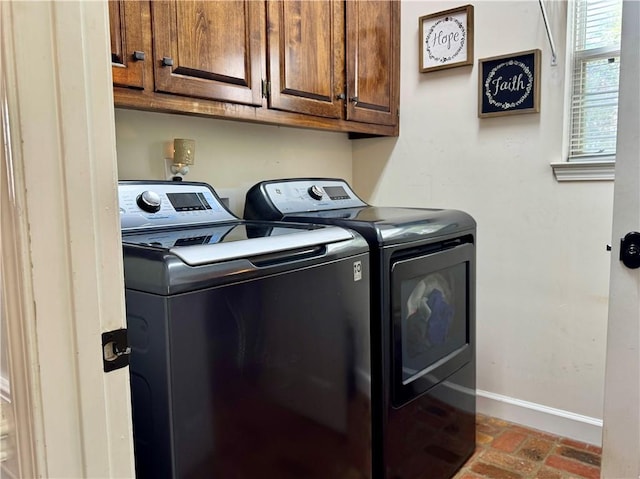 2200 Orourke Dr, Mobile, AL 36695 - laundry area featuring washing machine and clothes dryer, baseboards, brick flooring, and cabinet space