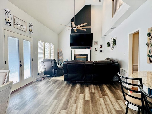 2200 Orourke Dr, Mobile, AL 36695 - living room with high vaulted ceiling, french doors, wood finished floors, ceiling fan, and a fireplace