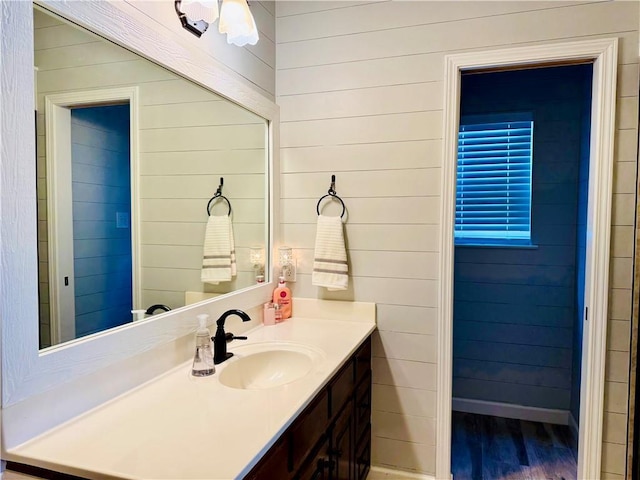 2200 Orourke Dr, Mobile, AL 36695 - bathroom featuring vanity, wood finished floors, and wood walls
