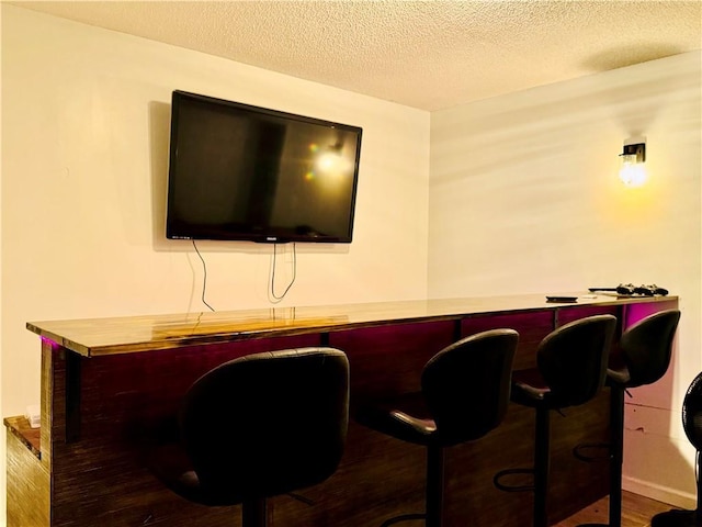 2200 Orourke Dr, Mobile, AL 36695 - bar area featuring a textured ceiling and wood finished floors