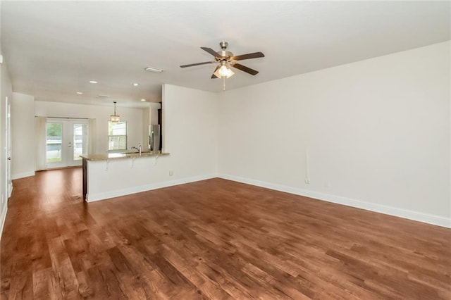 interior space with ceiling fan, dark wood-type flooring, sink, and french doors