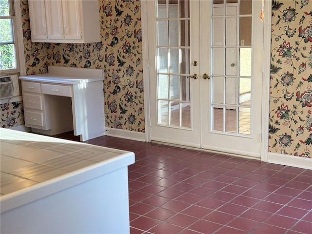 interior space featuring baseboards, wallpapered walls, and french doors