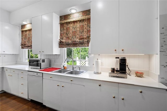 26 Julia St S, Mobile, AL 36604 - kitchen with stainless steel microwave, a sink, white dishwasher, light countertops, and dark wood-style floors