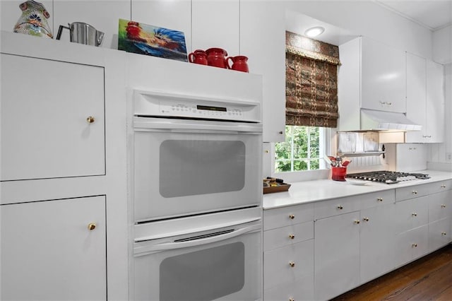26 Julia St S, Mobile, AL 36604 - kitchen featuring white double oven, gas stovetop, light countertops, dark wood finished floors, and white cabinetry