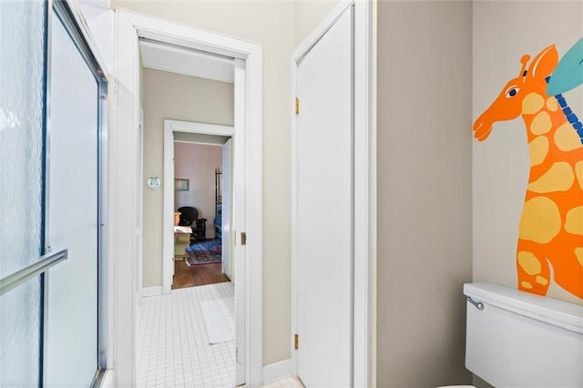 26 Julia St S, Mobile, AL 36604 - bathroom featuring toilet, tile patterned floors, and a shower with shower door