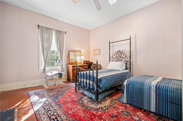 26 Julia St S, Mobile, AL 36604 - bedroom featuring wood finished floors, baseboards, a ceiling fan, and wallpapered walls