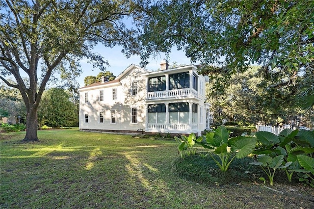 26 Julia St S, Mobile, AL 36604 - rear view of property featuring a sunroom, a yard, and a chimney