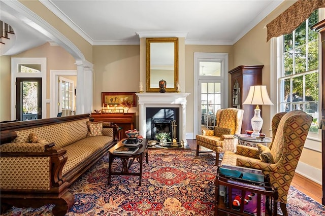 26 Julia St S, Mobile, AL 36604 - sitting room with plenty of natural light, wood finished floors, crown molding, a fireplace, and ornate columns